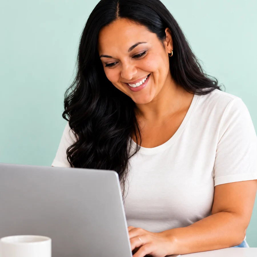 Joyce Agne smiling while working on a laptop
